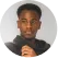 A man with glasses and a black jacket.