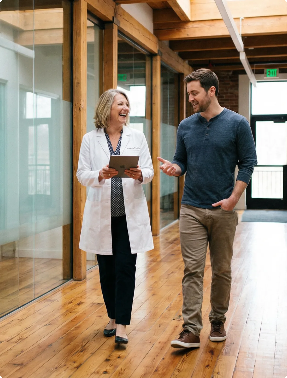 A man and a woman walking through a building.
